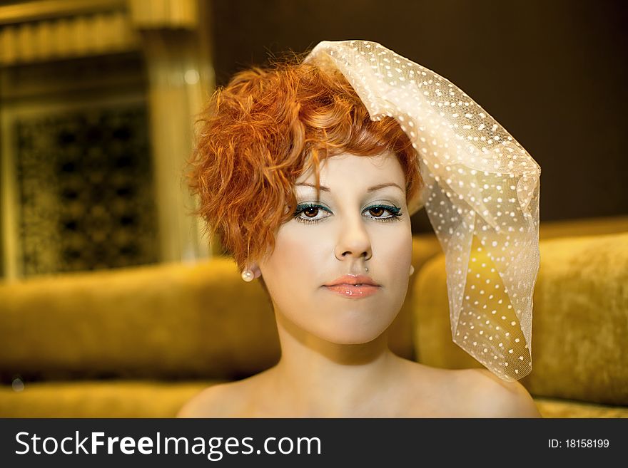 Luxurious girl with red hairs. veil