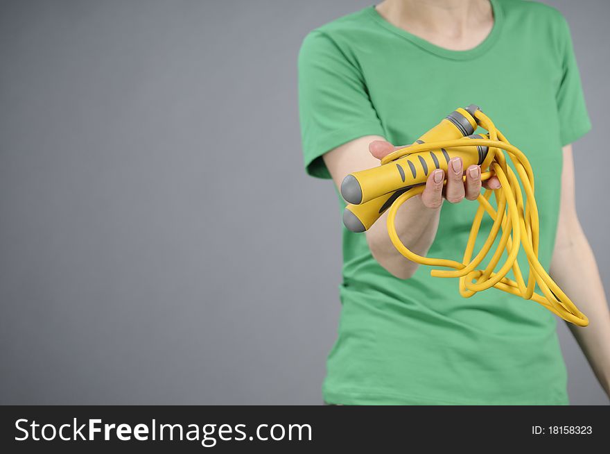 Human hand offering jumping rope. Human hand offering jumping rope