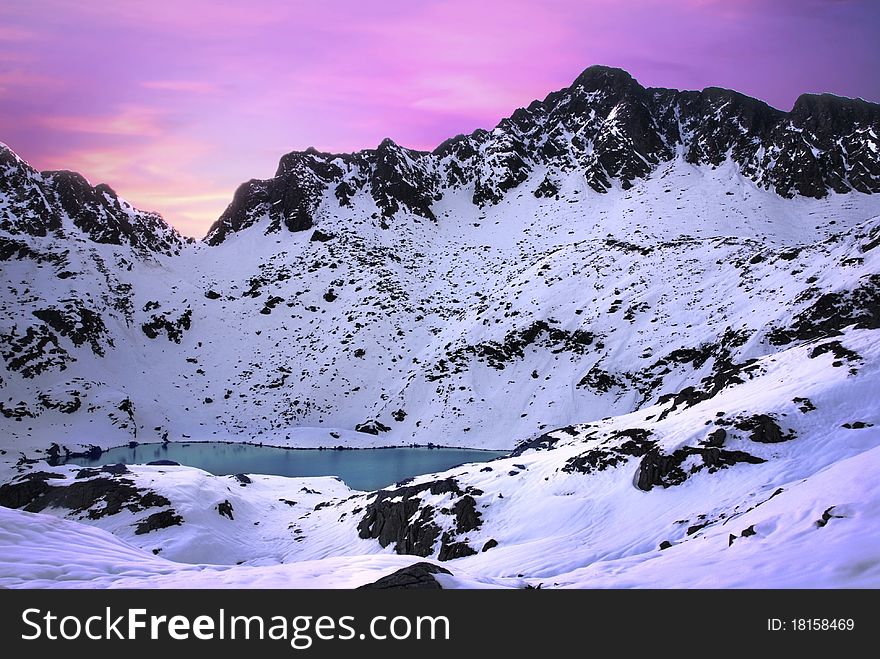 Glacier lake and the Alps mountains covered by snow at sunrise. Glacier lake and the Alps mountains covered by snow at sunrise.