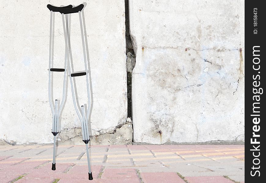 Background with the image of ferroconcrete wall and crutches. Background with the image of ferroconcrete wall and crutches
