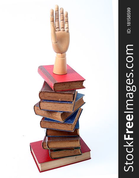 The wooden hand and old books. The wooden hand and old books