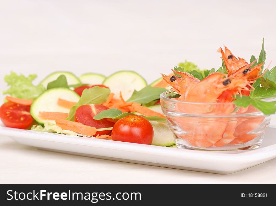 Fresh shrimps in a small glass bowl with mixed salad. Selective focus, shallow DOF. Fresh shrimps in a small glass bowl with mixed salad. Selective focus, shallow DOF