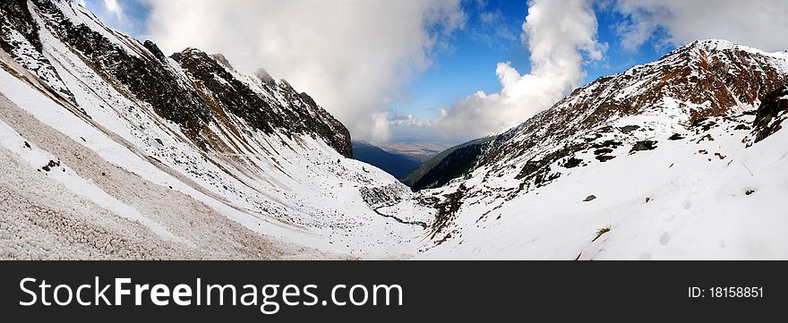 Canyon in the Alps mountains covered by snow. Panoramic photo. Canyon in the Alps mountains covered by snow. Panoramic photo