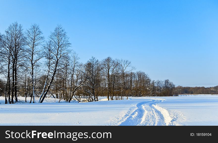 Deep trace of a powerful car on untouched snow under the cloudless blue sky. Deep trace of a powerful car on untouched snow under the cloudless blue sky