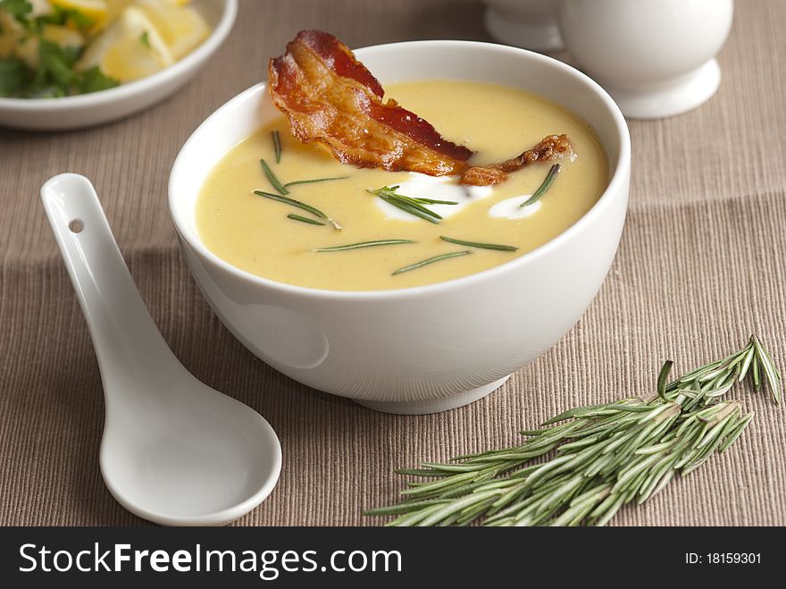 Butternut squash soup with crispy prosciutto in a bowl