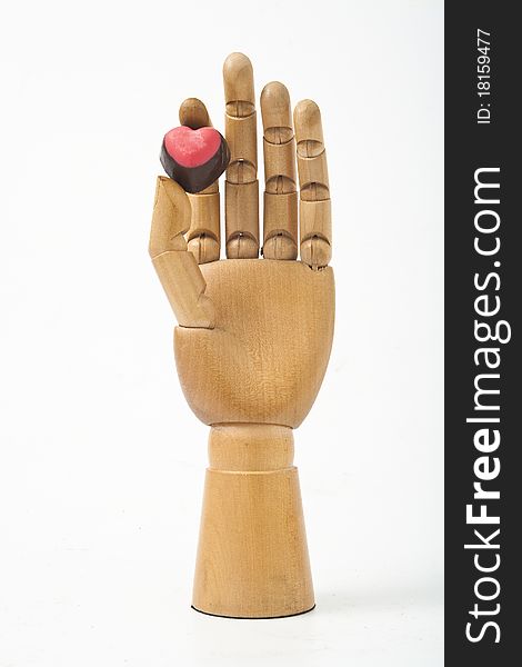 The wooden hand and red heart. The wooden hand and red heart