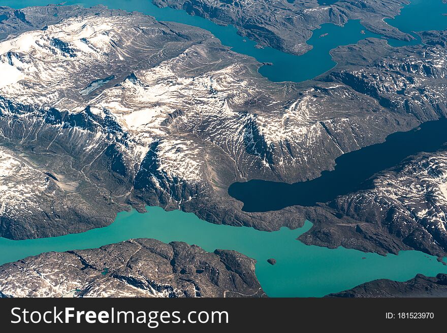 View at Greenland frozen mountains and glacier from above