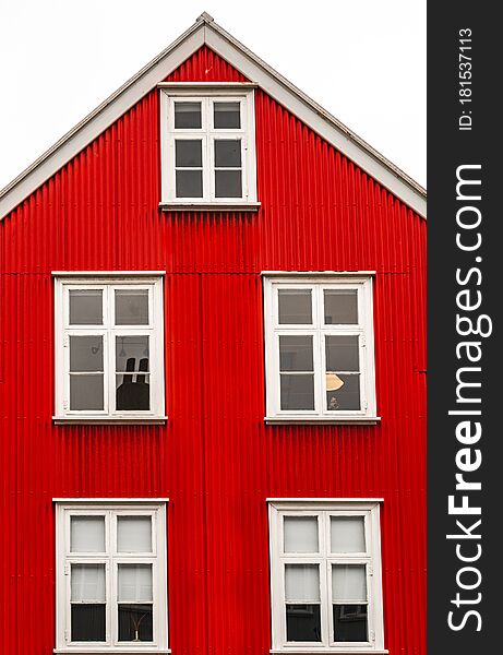 Street shot in Reykjavik center with old historic red sheet metal house