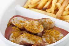 Curried Sausages And French Fries Royalty Free Stock Photography