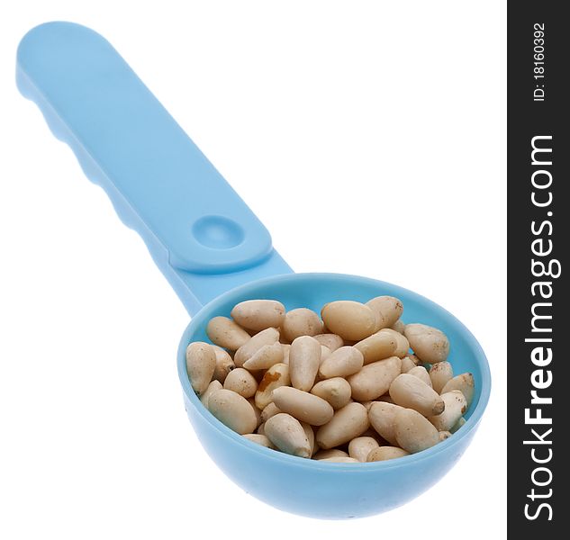 Pine Nut Seeds in a Blue Spoon Isolated on White with a Clipping Path.
