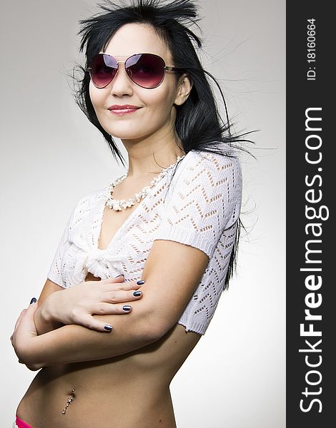 Glamour girl wearing sunglasses, looking in camera