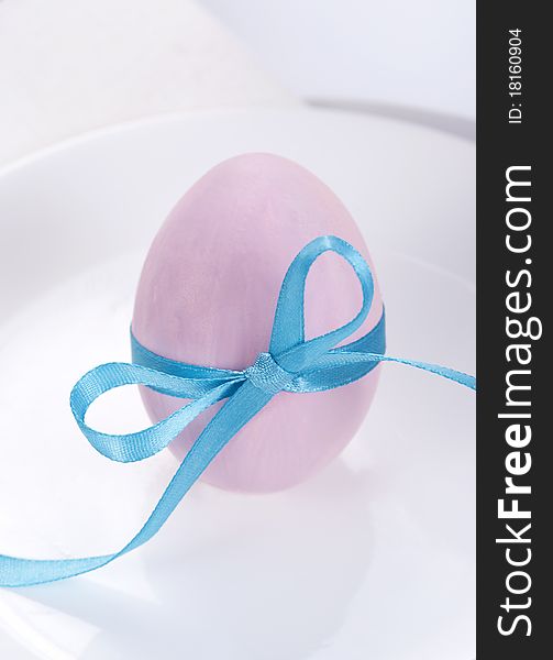 Easter table setting with plates, napkin and easter egg