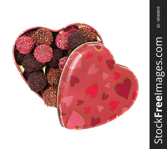 Chocolate truffles in heart shaped box on white background