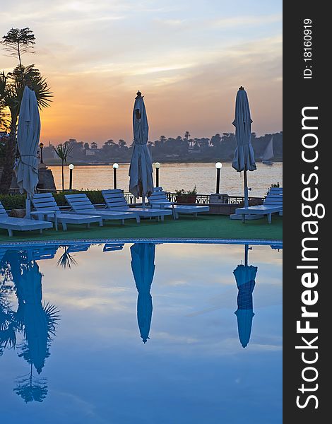 View from hotel swimming pool with sunset over a river in the background. View from hotel swimming pool with sunset over a river in the background