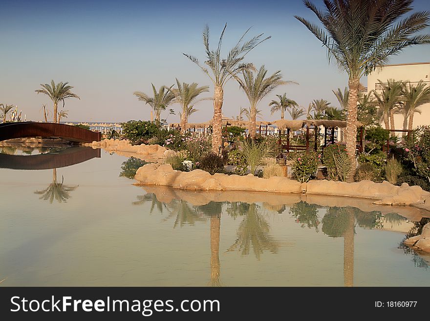 Egypt resort beach with artificial river, sepia.