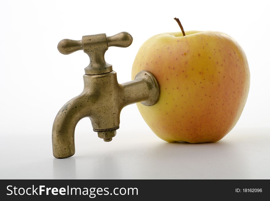 Apple with an old brass faucet. Apple with an old brass faucet