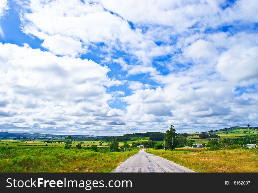 Route under a blue sky with white clouds. Route under a blue sky with white clouds