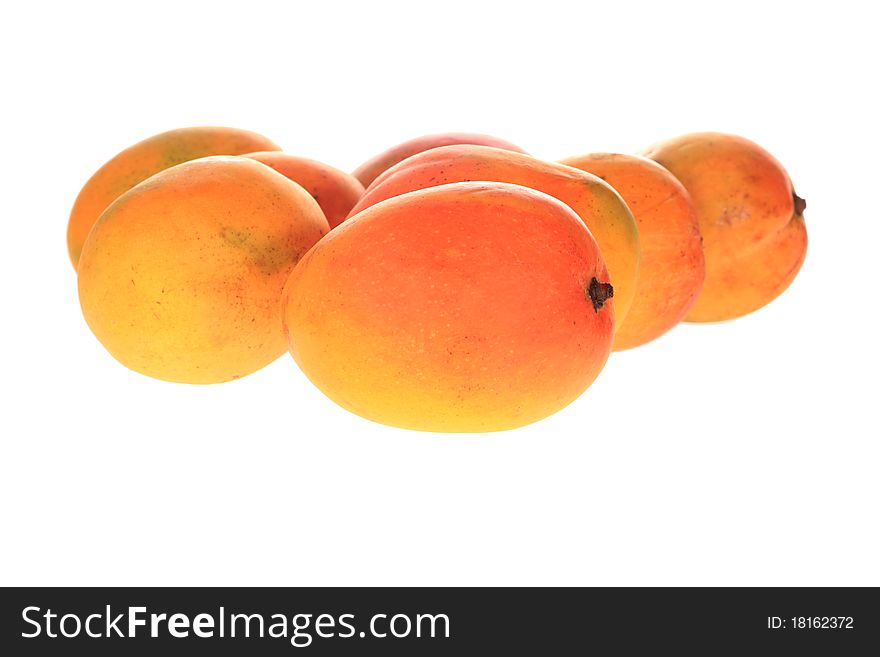 Group of fresh mangoes isolated over white