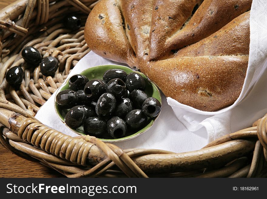 Chiabatta with black olives in the bakery basket. Chiabatta with black olives in the bakery basket