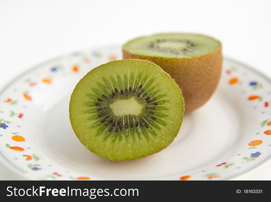Half of kiwi on dish white background