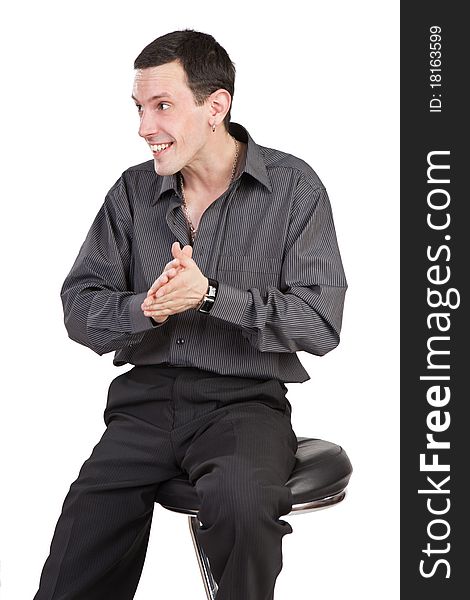 The young guy sits on a chair and rubs palms isolated on a white background. The young guy sits on a chair and rubs palms isolated on a white background