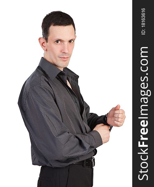 Young Man Buttoning-up A Sleeve Of His Black Shirt