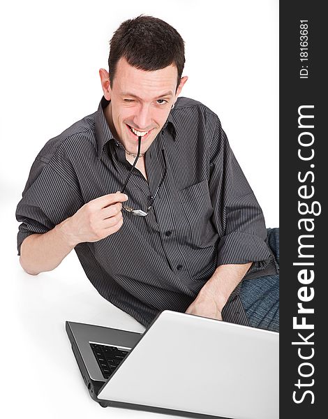 Young man lying on the floor working on his laptop. Young man lying on the floor working on his laptop