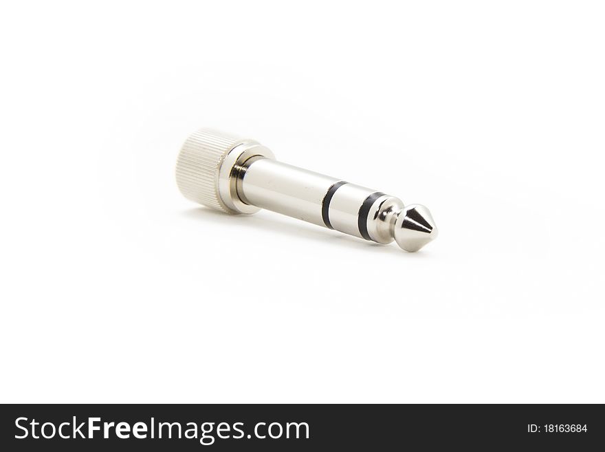 An silver colored audio connector isolated on a white background. An silver colored audio connector isolated on a white background