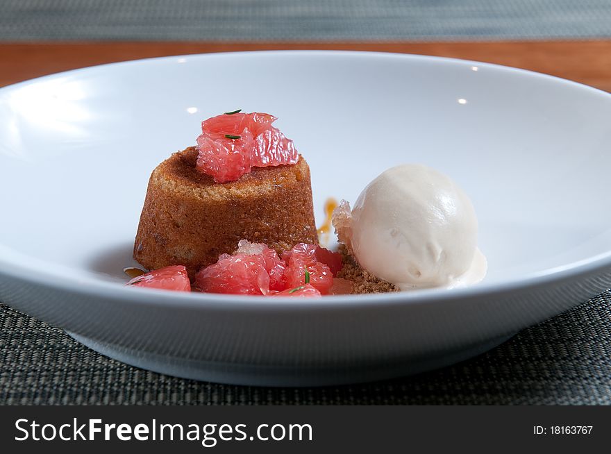 Brown sugar cake with fresh grapefruit and vanilla ice cream