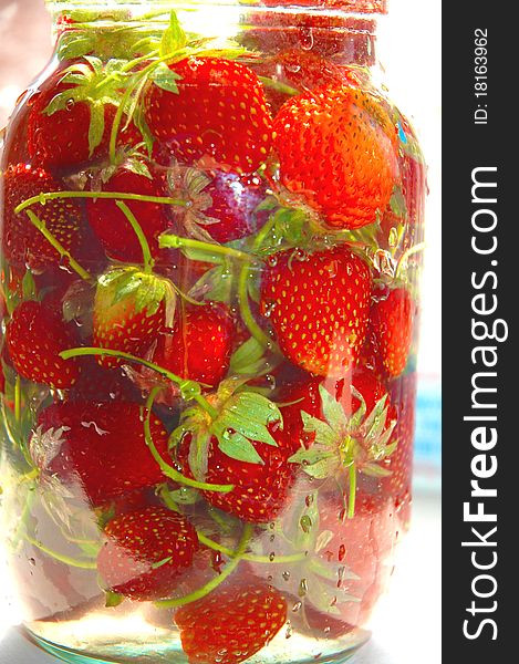 Strawberry in bank with water against