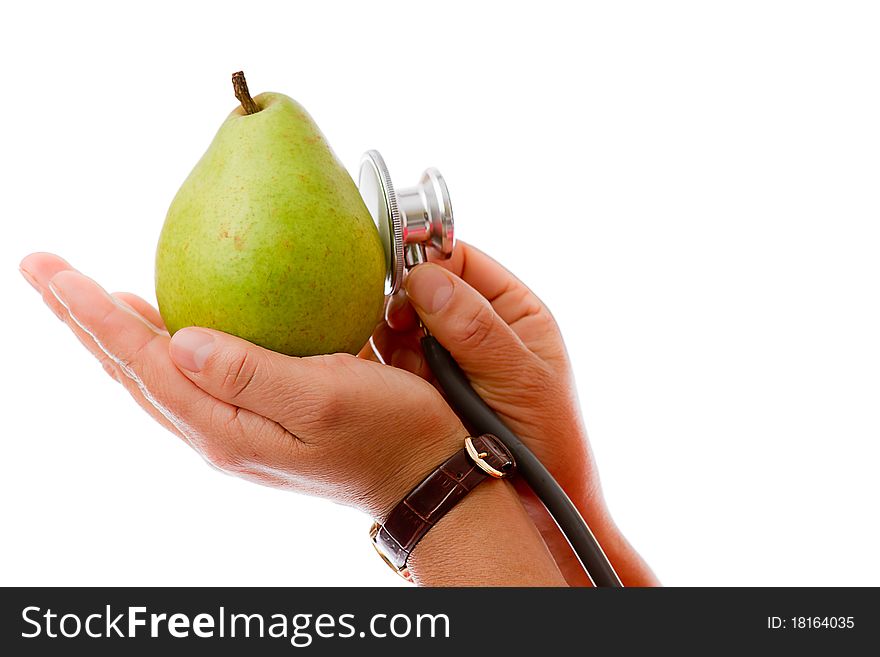 Hand Holding Pear and checking with stethoscope. Hand Holding Pear and checking with stethoscope