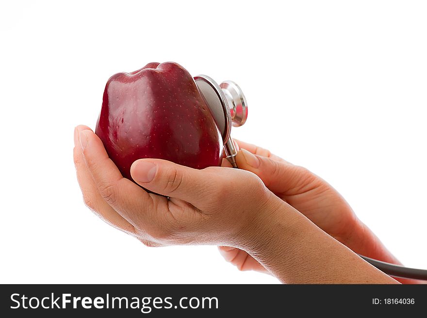 Hand Holding Apple and checking with stethoscope. Hand Holding Apple and checking with stethoscope