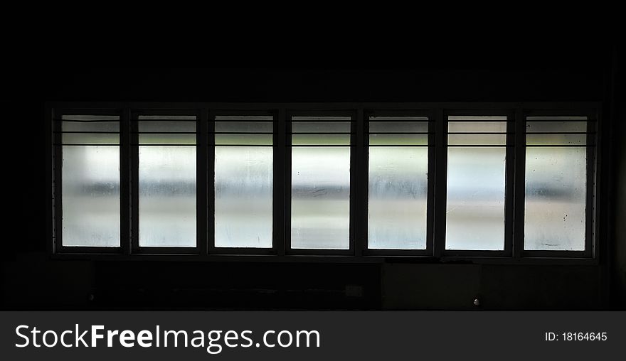 Windows in silhouette showing leakage of light.