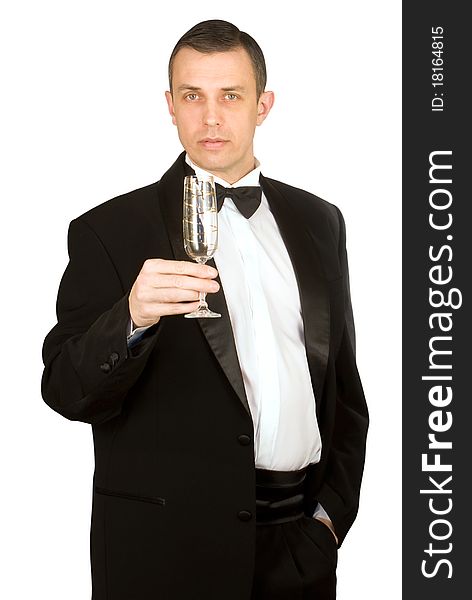 The imposing man in a classical tuxedo with a wine glass