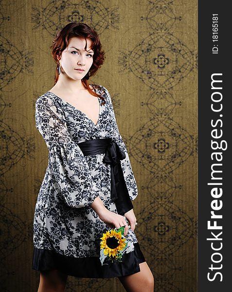 An image of young woman with sunflower