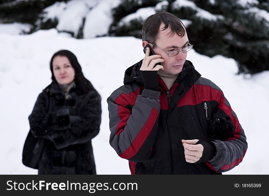 Jealous woman looking at his man talking on the phone