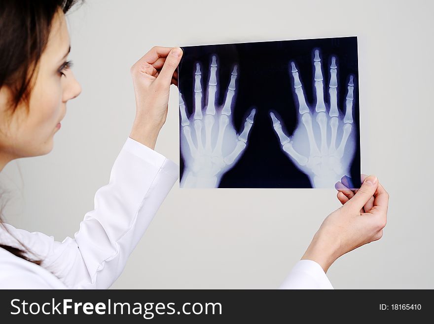 An image of a doctor examing x-ray. An image of a doctor examing x-ray