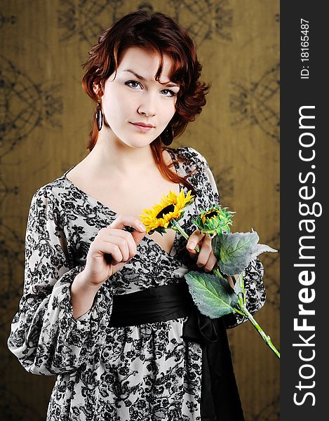 An image of young woman with sunflower