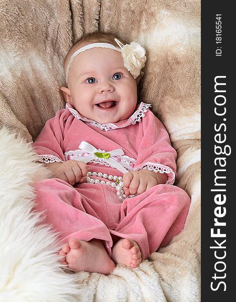 Smiling baby on a beautiful beige background
