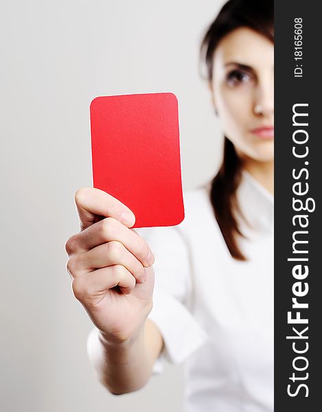 An image of beautiful woman showing red card