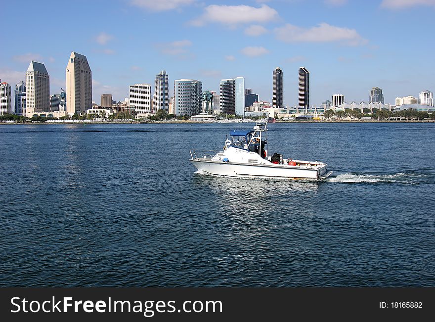 A cruising patrol boat with the San Diego skyline background. A cruising patrol boat with the San Diego skyline background.