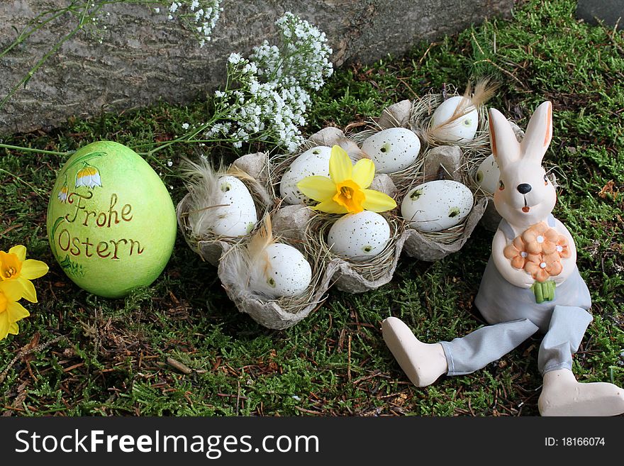 Easter bunny and easter eggs in the garden