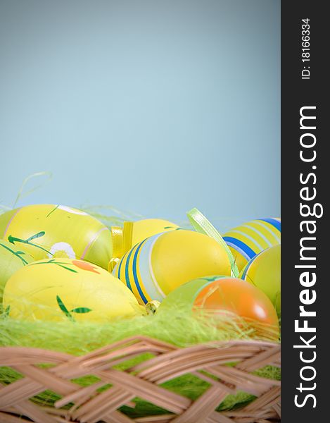Colorful Easter Eggs basket set on blue background