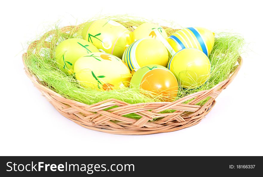 Easter basket with painted eggs on white background