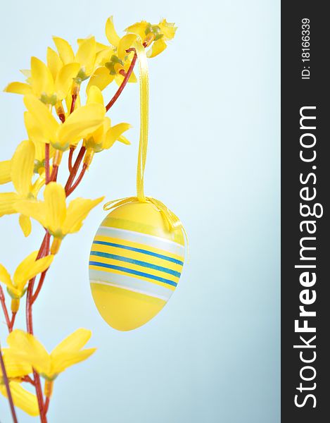 Hand-painted Easter egg on forsythia branches