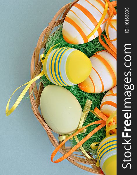 Colorful Easter Eggs basket set on blue background