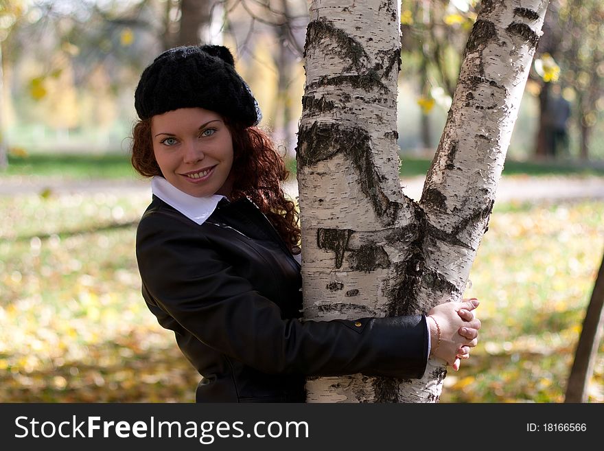 Curly beautiful smiling girl in autumn park. Curly beautiful smiling girl in autumn park