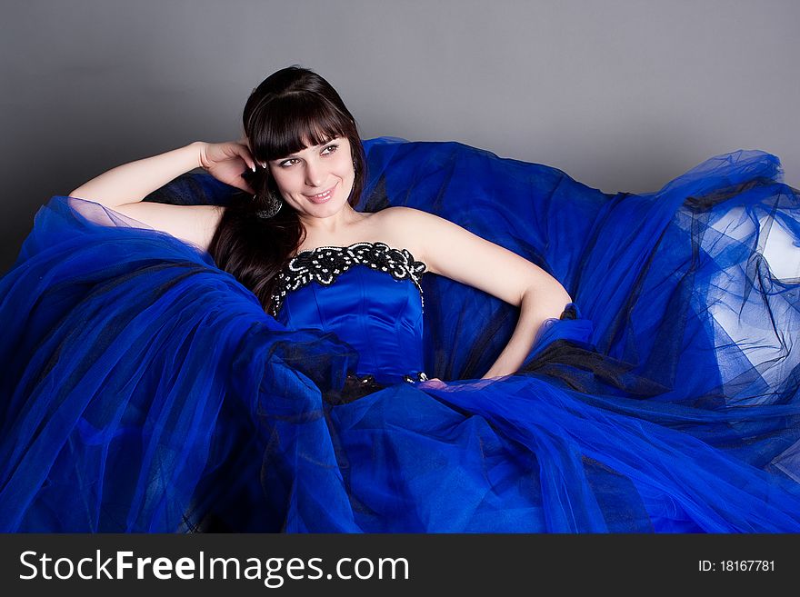 The girl in a dark blue evening ball dress. The girl in a dark blue evening ball dress