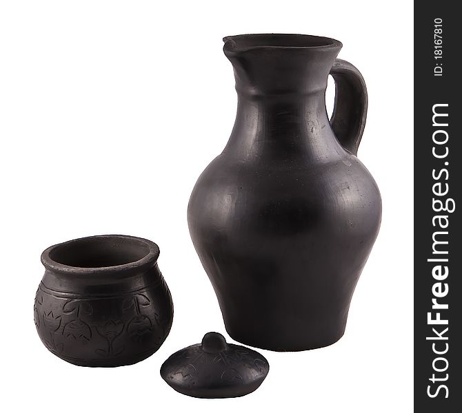 Pottery from black clay on white background