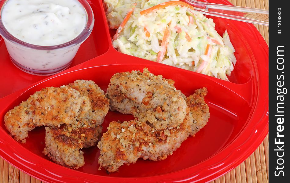 Chicken strips with coleslaw and dipping sauce. Chicken strips with coleslaw and dipping sauce